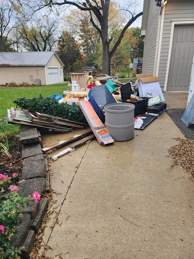 Dumpster being loaded with debris for Estate Cleanout Dumpster Rental in Elburn